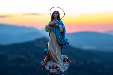 Bella escultura de la Virgen María al amanecer - obrazy, fototapety, plakaty