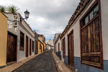 Cobbled street with wooden doors and windows in the historic center of Garachico, Tenerife, Canary Islands, Spain