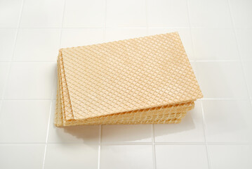 Close up of stack of wafer or waffle sheets on a white background. Shallow depth of field