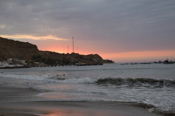 Fototapeta premium sunset over mancora beach with fisher boats, peru