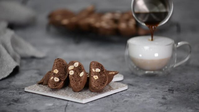 Chocolate biscotti with hazelnut and cup of coffee latte.
