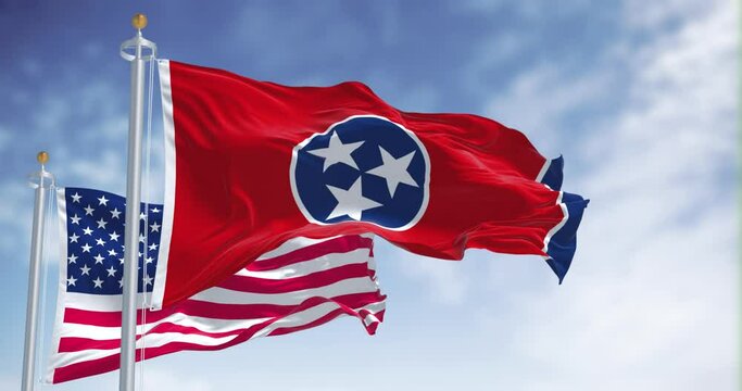 The Tennessee state flag waving along with the national flag of the United States of America