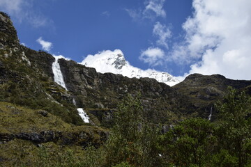 A beautiful waterfall falls from a high mountain, on the way to Lagoon 69. Huascaran National Park in the Sands of Peru