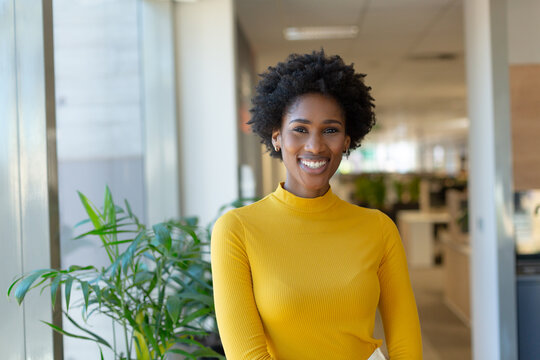 Portrait of happy beautiful african american young female advisor at modern workplace