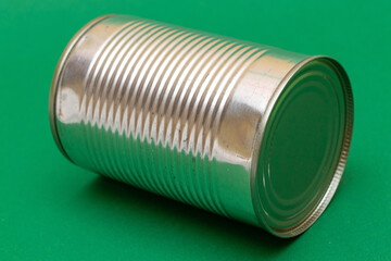 Unopened Tin Can with Blank Edge on Green Background. Canned Food. Aluminum Can for Safe and Long Term Storage of Food. Steel Sealed Food Storage Container
