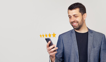 Businessman giving a five star rating. Customer service experience and business satisfaction survey. Businessmusing smart phone with icon five star symbol to increase rating of company concept - obrazy, fototapety, plakaty