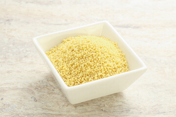 Raw couscous in the bowl