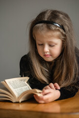 little girl is reading a book