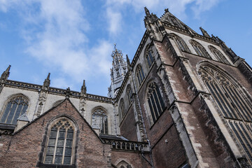 Fototapeta na wymiar St. Bavo Church (Sint-Bavokerk, Grote Kerk) is in the center of Haarlem’s main square, Grote Markt. First built as Catholic church in 1245, enlarged in 1559. Haarlem, North Holland, the Netherlands.
