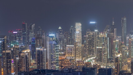 Fototapeta na wymiar Panoramic skyline of Dubai with business bay and downtown district night timelapse.