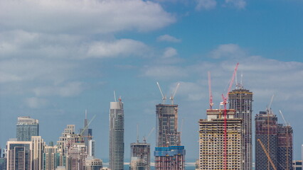 High multi-storey buildings under construction and cranes timelapse