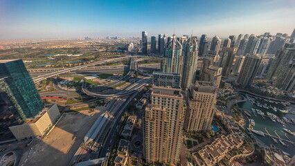 Fototapeta premium Dubai marina and JLT skyscrapers along Sheikh Zayed Road aerial timelapse.