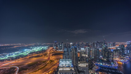 Fototapeta na wymiar Dubai marina and JLT skyscrapers along Sheikh Zayed Road aerial night timelapse.