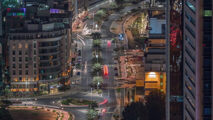 Aerial view of a road intersection in a big city night timelapse in Media city