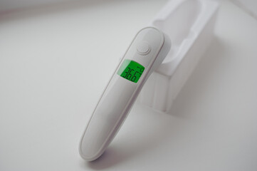 Non-contact thermometer on a white background for measuring body temperature