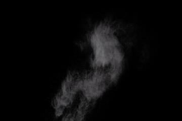 White powder explosion on black background. Colored cloud. Colorful dust explode. Paint Holi.