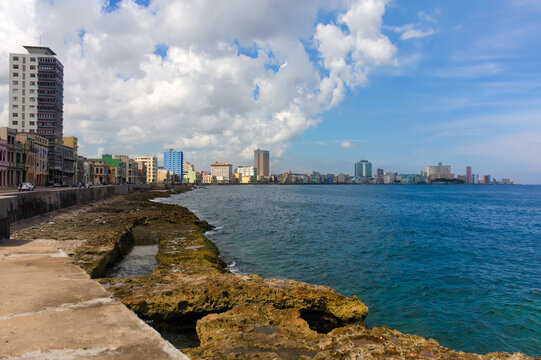 Promenade in Havana, Cuba, the Malecon, overlooking the turquoise Caribbean Sea in the Atlantic Ocean. Image was taken on a bright warm summer day.