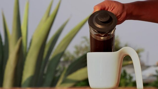 French press coffee brew poured in a cup, morning lovely homemade breakfast inside the house