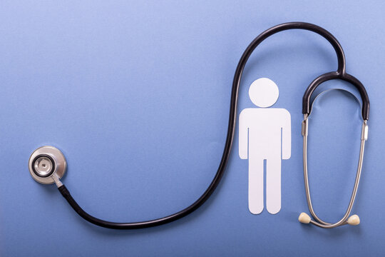 Directly Above Shot Of Paper Man With Stethoscope Against Blue Background, Copy Space