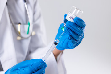 Midsection of african american mid adult woman wearing gloves holding vial and syringe