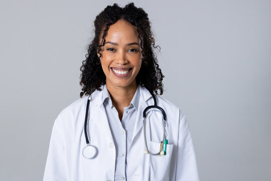 Portrait of happy african american mid adult female doctor with stethoscope against white background