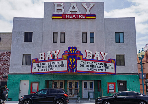 Seal Beach, California, May 8, 2022: Historic Bay Theatre in Seal Beach California, opened in 1947 in the Los Angeles suburb, a late example of streamline moderne style with restored neon signs.