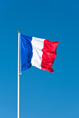 Fototapeta na wymiar Flag of France waving in the wind