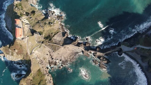 The isthmus on a peninsula between two seas. Aerial drone view of the island and the Gaztelugatxe temple.
