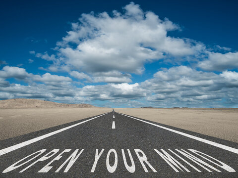 Open Your Mind text on road.