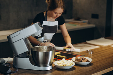 confectioner prepares dough for sweet in a modern kitchen