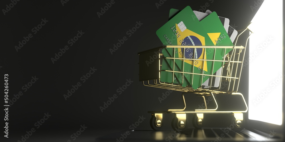 Poster credit card mockups with flags of brazil in a small shopping cart on the laptop. 3d rendering