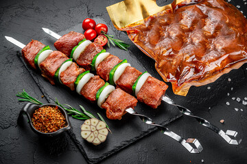 Vacuum-packed grilled meat, on a dark background.