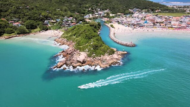 Aerial drone image of tropical beach with many people enjoying the sea walking and diving boats passing blue sea summer vacation fishing district with channel high season