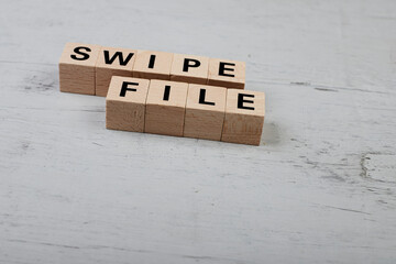 wooden blocks building the word SWIPE FILE