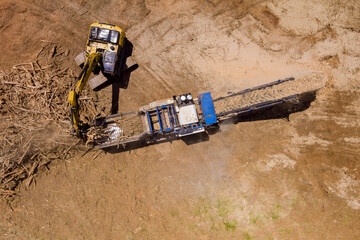 Construction site view with work wood chipping machine the chipper process on aerial top