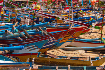 Fototapeta na wymiar Fishing boats, lined up on the Jimbaran beach, Bali, Indonesia