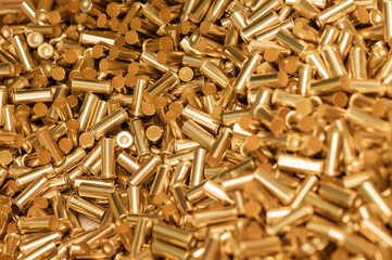 Pile of golden shells of bullets as background close view