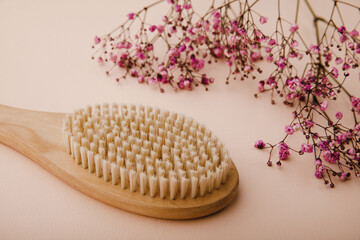 Wooden massage brush with natural bristles close-up for healthy and firm skin