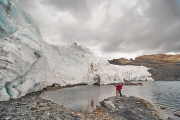 Couple of tourists hugging each other taking a picture on Pastoruri glacier