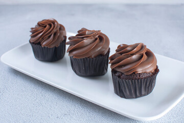 Rum flavored chocolate cupcake displayed on gray background
