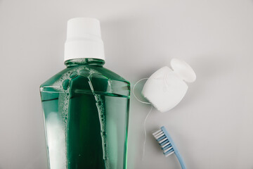 Teeth brushing concept with toothbrush, mouthwash and dental floss close-up