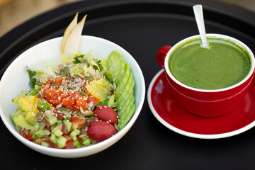 Healthy salad of fresh vegetables - tomatoes, avocado, corn salad, pea sprouts and chia seeds in bowl. Paleo diet menu.
