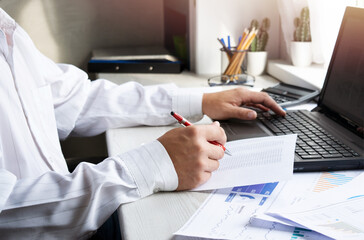 Finance and business concept. Business man working with laptop and documents. Mobile technologies, internet, vintage color, selective focus.