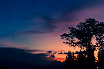 Fototapeta na wymiar Silhouette of volcano and mountains from Guatemala City, sunset and spectacular colors in space.