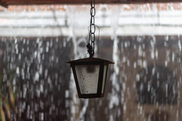 old lantern on the wall and rain