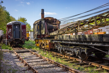 Obraz premium old and abandoned railway carriages and rail industry equipment in a disused railway yard