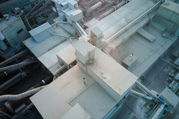 Cement plant with high factory structure and tower cranes at industrial production area. Manufacture, global industry and air pollution concept