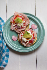 Ham tostadas with cheese and avocado. Mexican food
