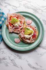 Ham tostadas with cheese and avocado. Mexican food