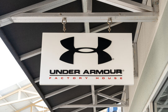 Houston, Texas, USA - March 2, 2022: Under Armour store hanging sign at an outlet mall in Houston, Texas, USA, an American sports equipment company that manufactures footwear, sports and casual appare